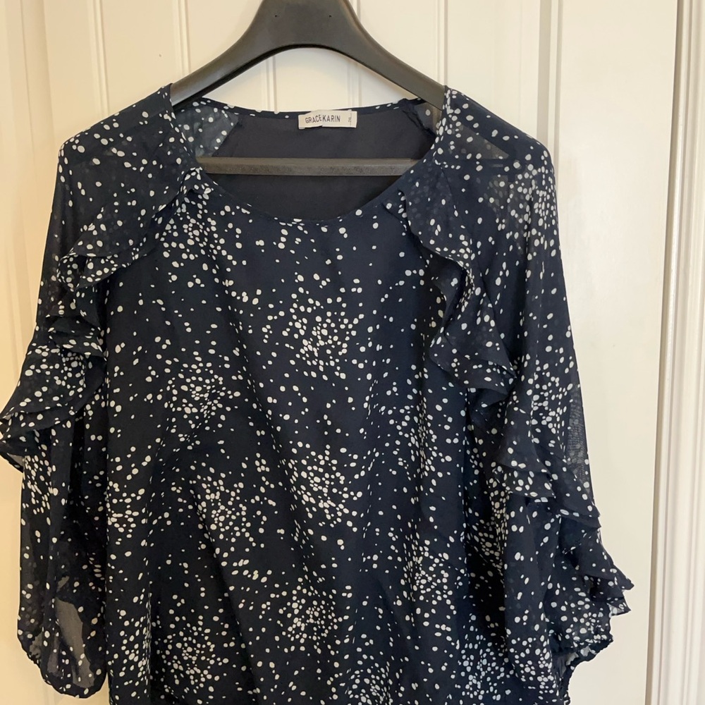 Navy & white top with 3/4 sleeves and ruffle detail from neck down the sleeves